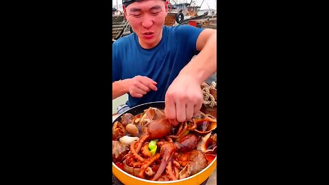 Chinese fisherman cooking and eating fresh seafood