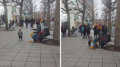 Toddler Grooves To The Beat Of Street Drummer's Performance