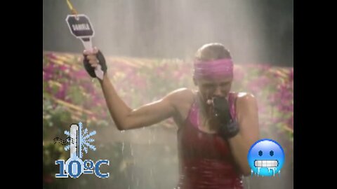 Big Brother show. Cold water challenge. Woman is shivering cold ice streams of water.