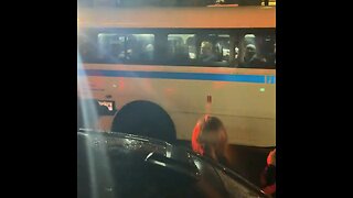 Crowd Cheers On The NYPD Bus Filled With Columbia Protestors Leaving Campus