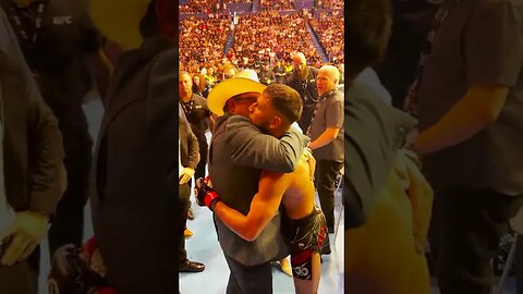 Following his interim featherweight championship victory, Yair hugs his family.