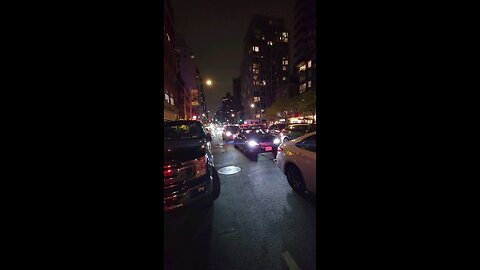 Walking to Baruch College at night. East 23 St and 3 Ave NYC. May 1, 2024.