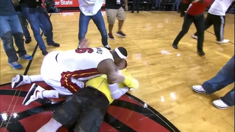 LeBron James tackles Miami heat fan and the whole court goes nuts😱