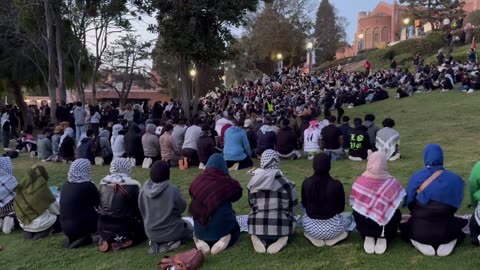UCLA Group of Pro Palestine protestors praying as the sun sets on campus