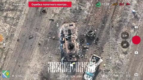 Drone Drops Supplies to Wounded Russian Servicemen Hiding in a Burnt Armored Vehicle