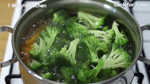 Fried broccoli with vegetables in a pan. Delicious and quick recipe.