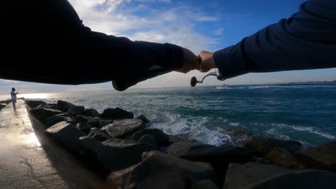 Fisherman Knocked Down by Wave While Fighting a Large Catch