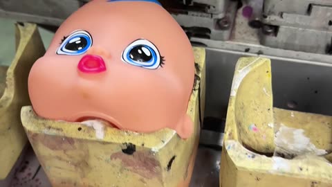 Manufacturer Paints Doll Heads