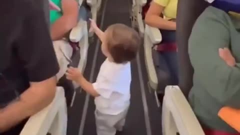 Cute baby shaking hand to all the flight passengers