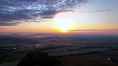 Drone captures stunning sunrise over mist enshrouded farm country