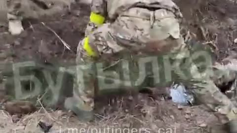 Ukrainian soldiers burying one of their own alive