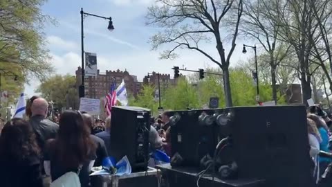 A dog sings the American National Anthem while participating in a patriotic protest at MIT