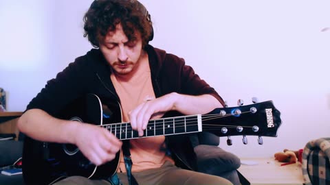 Dishevelled man tries to play a $2,000,000 song on a $200 guitar