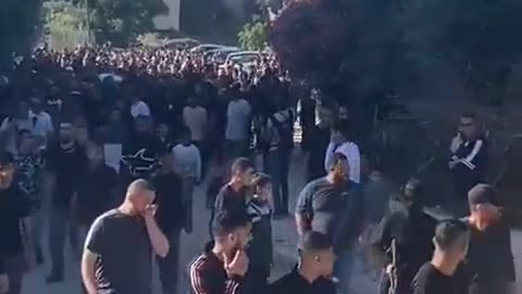 Armed terrorists accompany the funeral procession of the terrorist Omar al-Ufi,