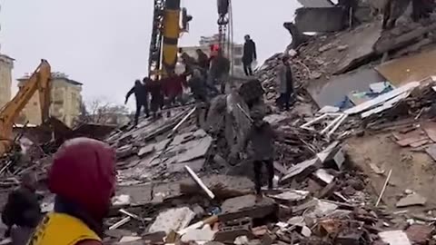 Moment building collapses in Turkey as rescuers continue earthquake searches