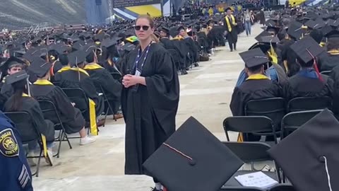 Michigan graduates _boo_ University of Michigan President_ Santa Ono_ during commencement.