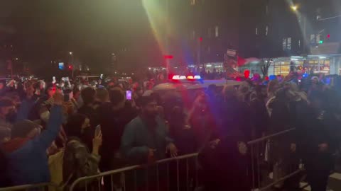 NYPD car currently driving through a crowd of protesters on 113th