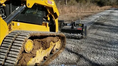 CAT 259D3 grading mile long driveway with Harley Rake Illinois homestead