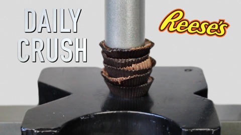 Crushing peanut butter cup candy with hydraulic press