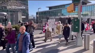 Sign Says ARREST FAUCI: New Yorkers Protest Outside United Nations & Pfizer Buildings Shouting Nuremberg