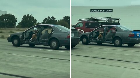 Positive-energy dude has a blast riding his doorless car