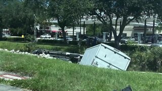 Truck runs red light, collides with van then crashes into canal