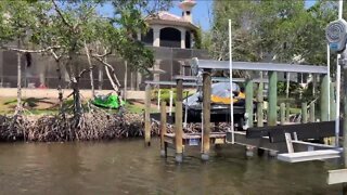 Removing vehicles and debris from water after Hurricane Ian