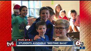 Elementary school students put together bags of supplies for homeless children