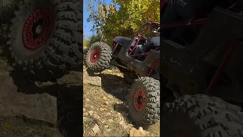 Jeep Climbing Up Rock Hill