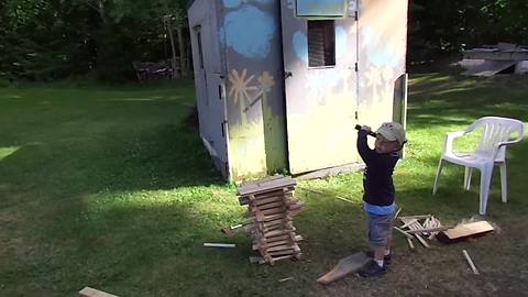 "A Tot Boy Knock Down A Pile Of Sticks"