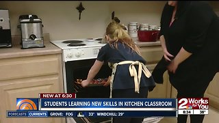 Students learning new skills in kitchen classroom