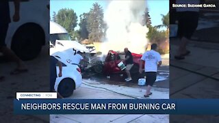 Neighbors rescue man from burning car