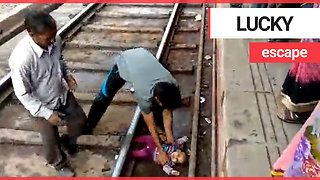 Baby has miraculous escape after slipping under moving train