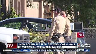 UPDATE: Man found trapped between car and wall in northeast Las Vegas