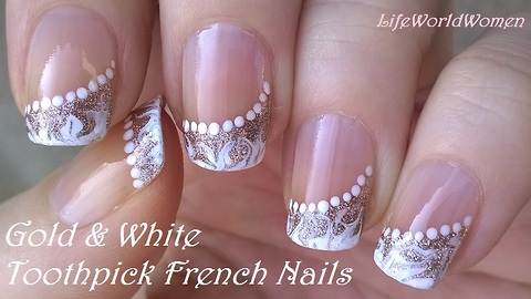 Gold & white side French manicure: Elegant drag marble nail art by toothpick