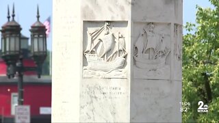 Group celebrates with dance and celebration around remaining Christopher Columbus pedestal