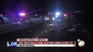Box truck rolls over, scatters debris along I-15