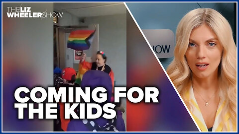 Teachers wave Progress Pride flag in front of YOUNG KIDS