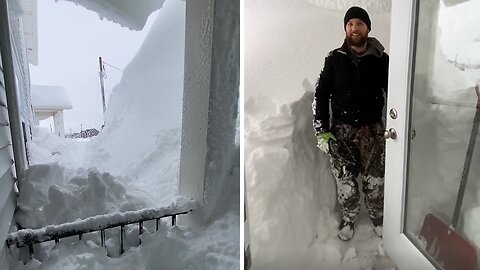 Canadians show the ten feet of snow in front of the house after a blizzard