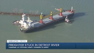 Canadian and US officials are working to get a stuck freighter free in the Detroit river.
