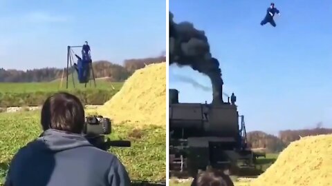 Acrobat performs insane stunt over high speed train