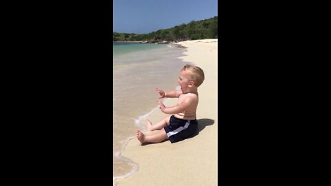 Cute beach baby scared of waves