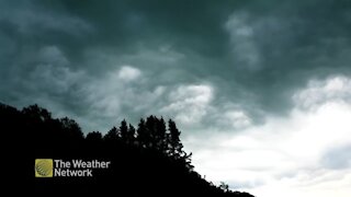 Dark clouds swirl and shift over Alberta