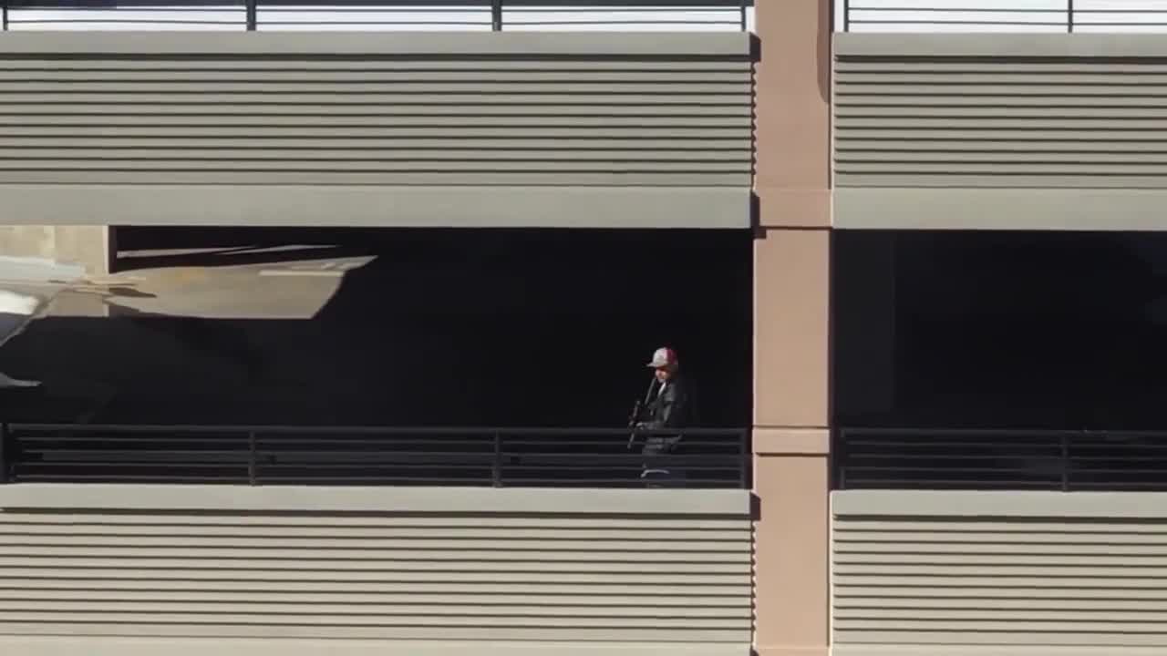 Man armed with a rifle pacing back and forth in Denver parking garage