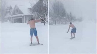 Kid surfs the snow in board shorts