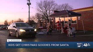 Kids get Christmas goodies from Santa