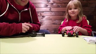 Little girl helps dad review remote control car