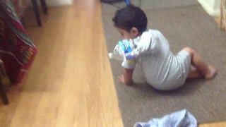 Funny Tot Boy Spins In Circles Trying To Get The Bottle