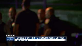 Crowds gather at the medical examiner's office to honor fallen officer