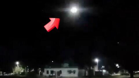 A UFO flashing in the sky at night, but it looks like a helicopter.
